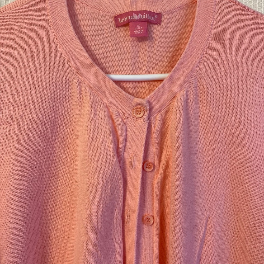 Cute peach colored short sleeve sweater.
